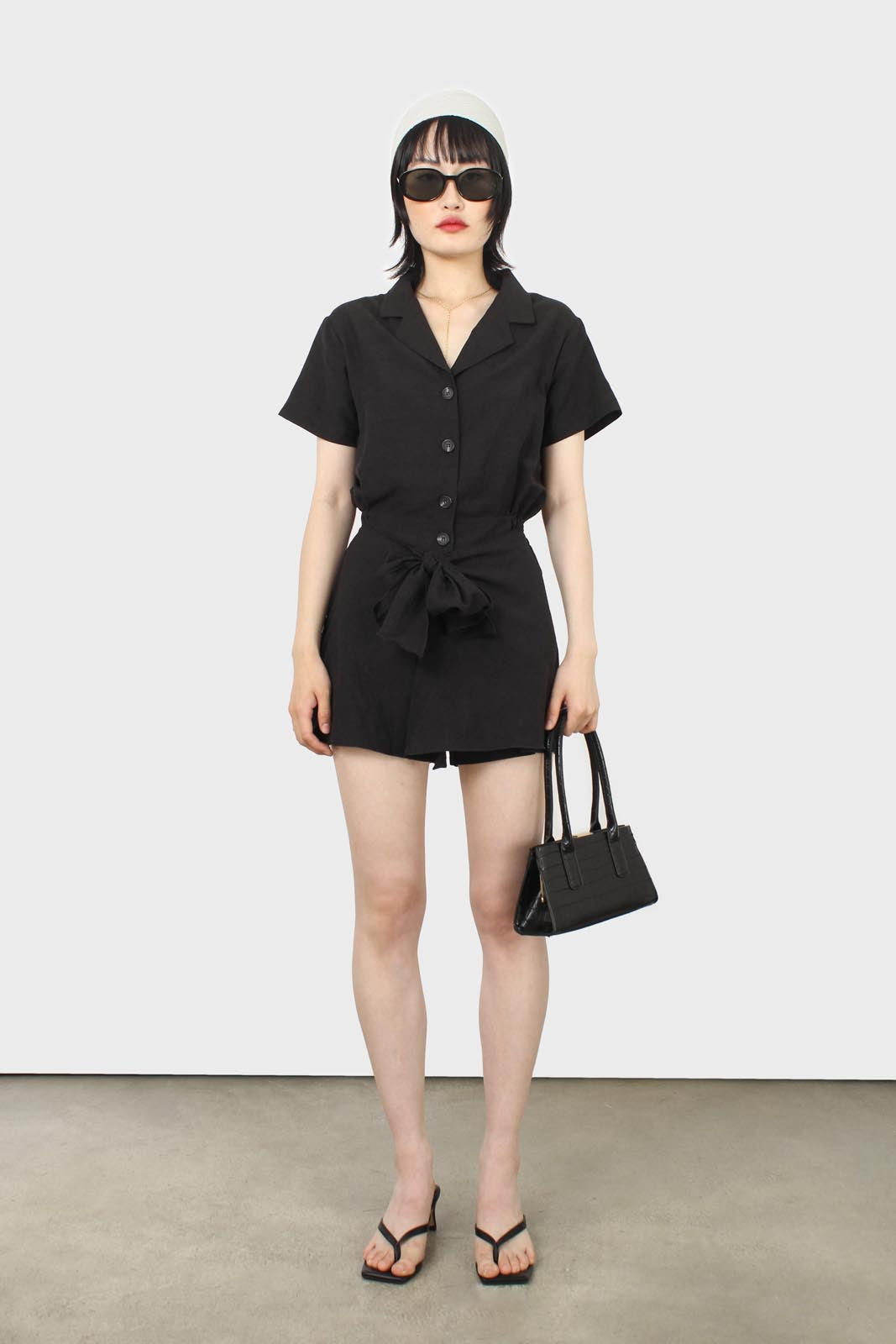 Black short sleeved button up tie waist romper_6