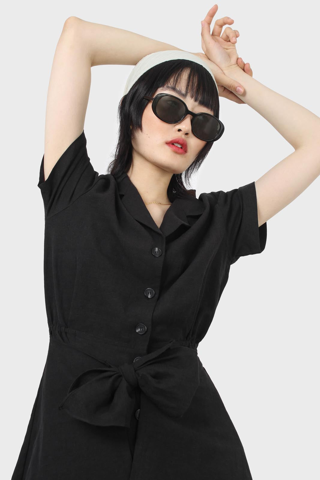 Black short sleeved button up tie waist romper_5