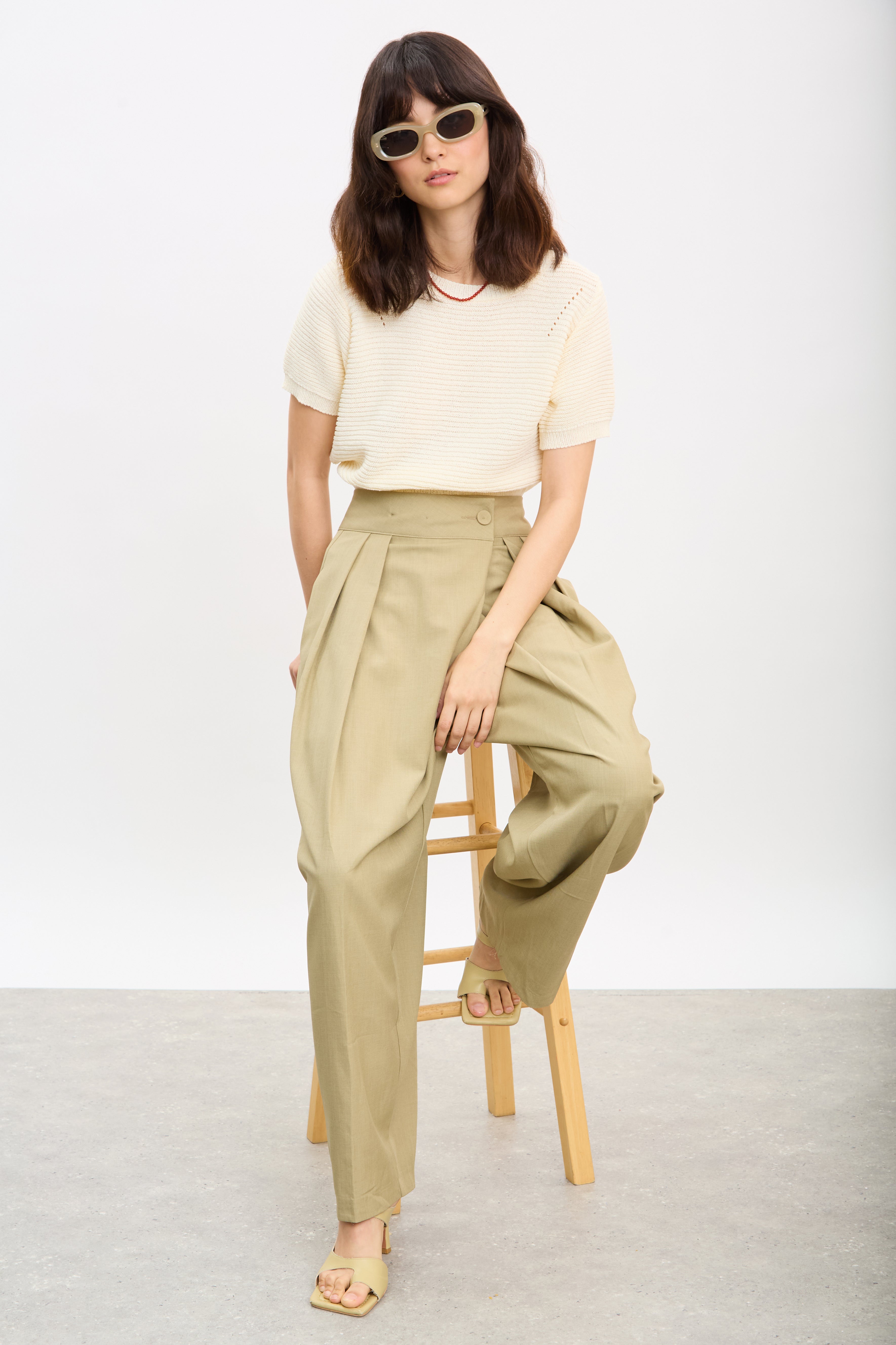 Beige multi pleat side button trousers_5