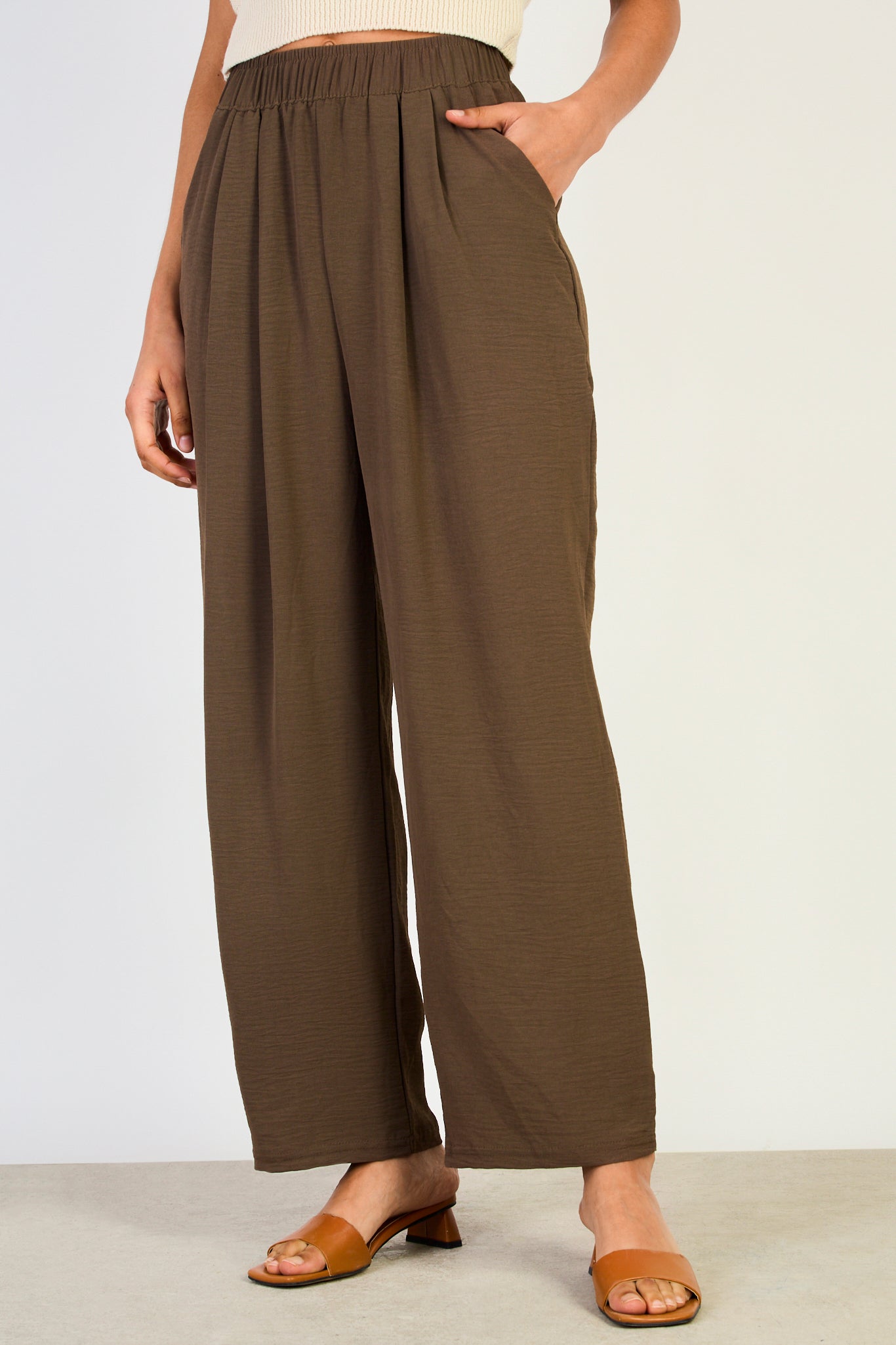 Brown crinkled relaxed trousers_1