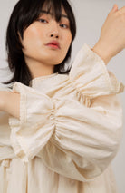 Beige ruffle trim seamed yoke blouse_11