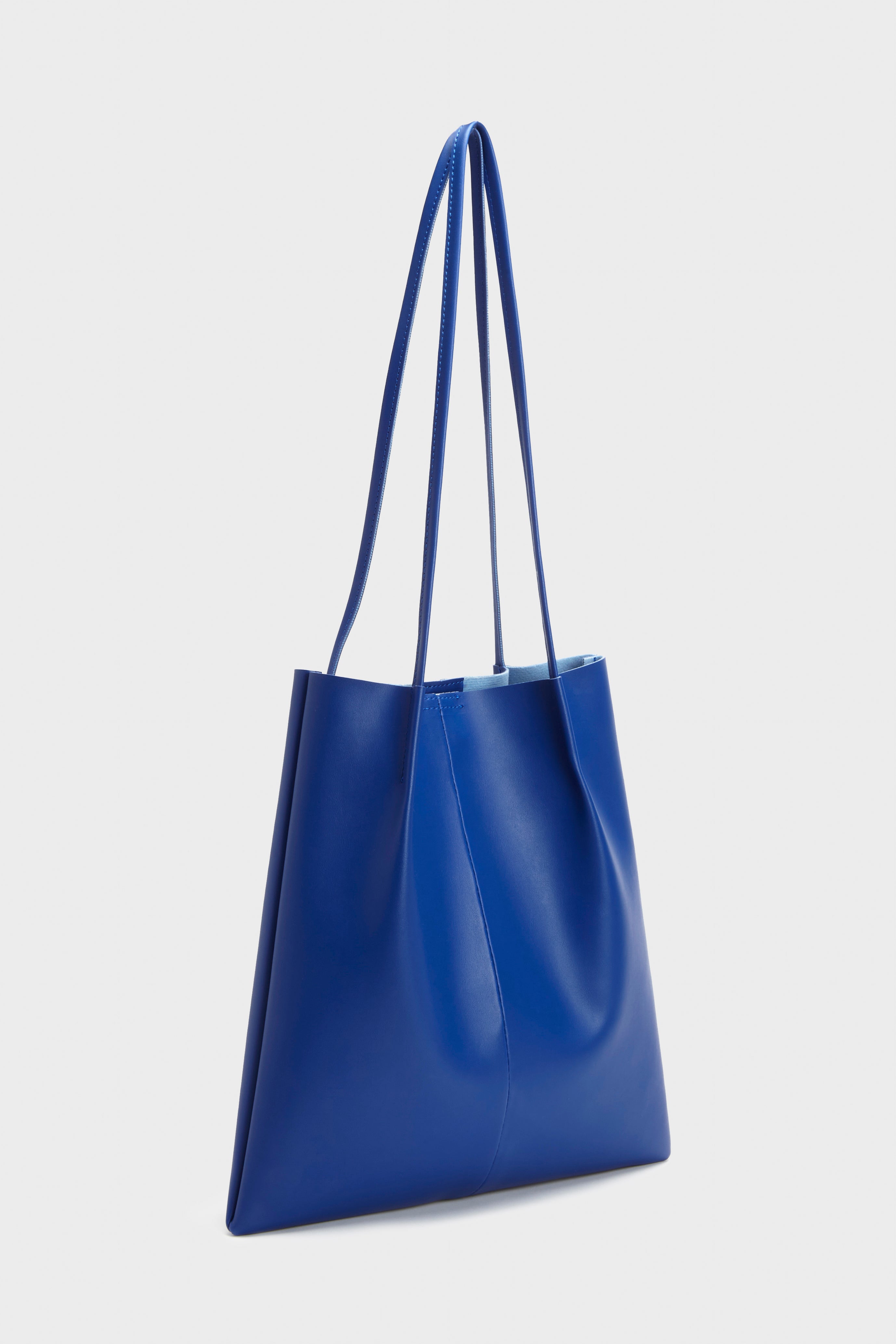 Cobalt blue vegan leather pinched strap tote bag