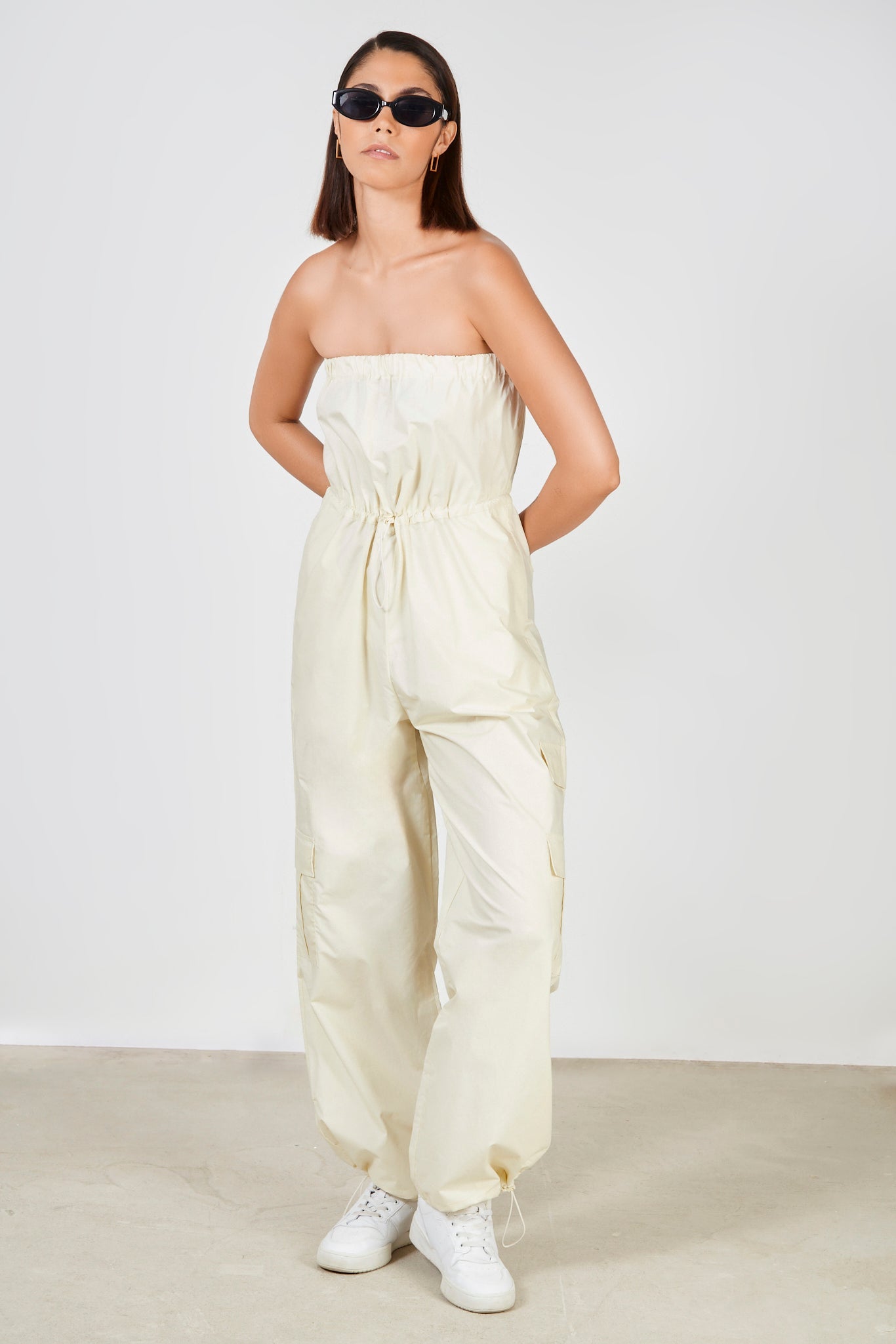 Cream strapless cinch waist jumpsuit