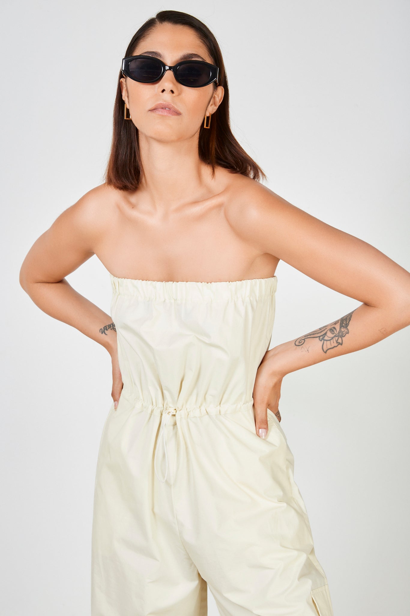 Cream strapless cinch waist jumpsuit