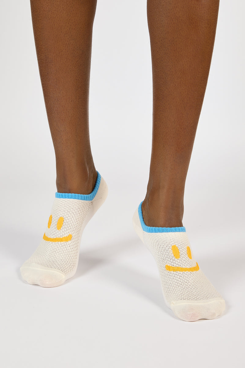 Pale yellow and blue giant smiley face pop socks | Glassworks London