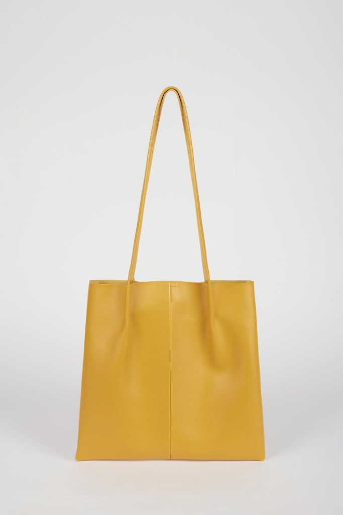 Mustard vegan leather pinched strap tote bag_1