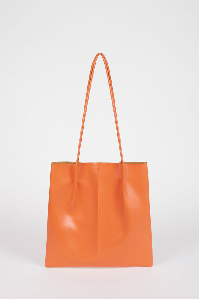 Orange vegan leather pinched strap tote bag_1