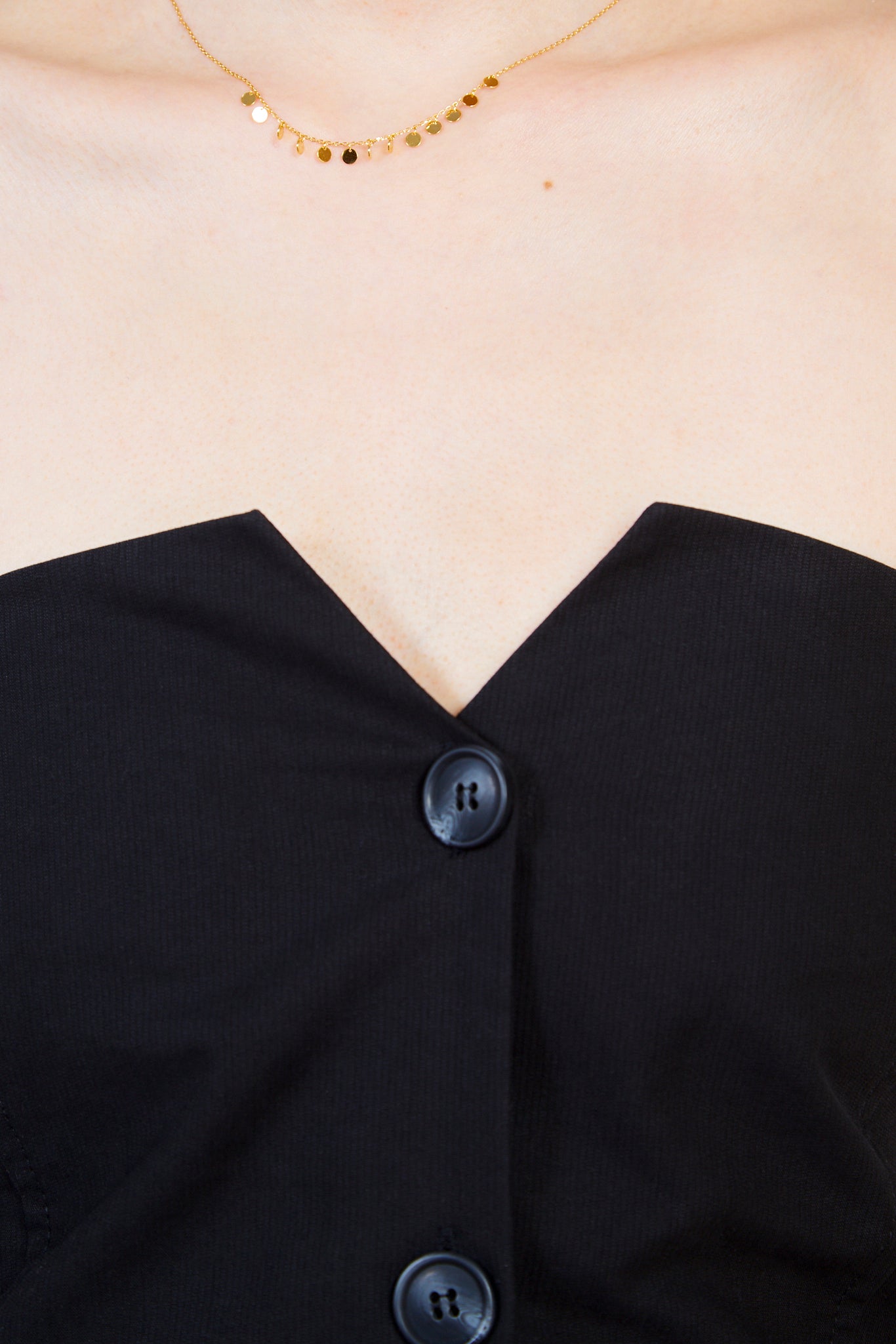 Black button front strapless top