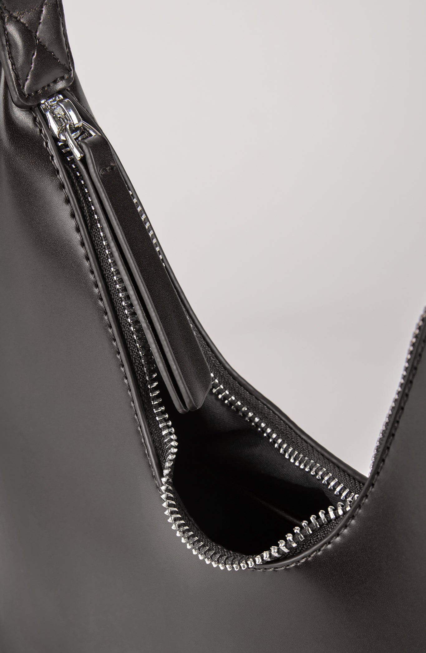 Black vegan leather shaped shoulder bag